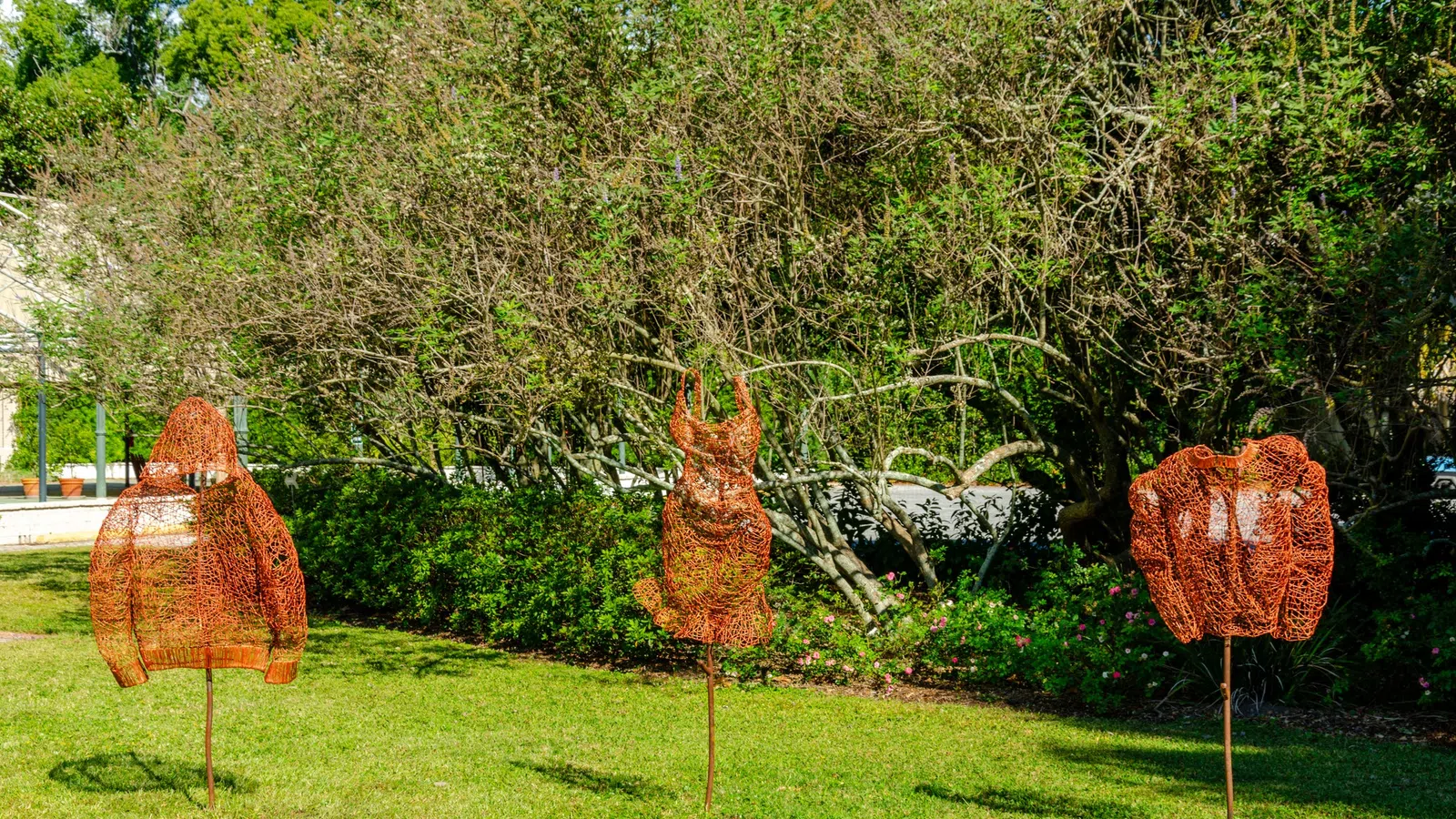 a group of trees with a deer statue in the middle