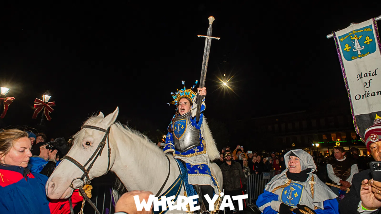 a person in a garment riding a horse with a crowd watching