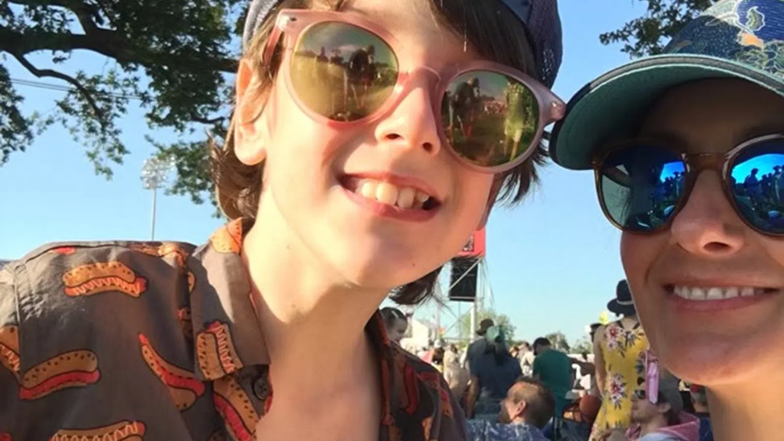 a couple of women wearing sunglasses and smiling at the camera