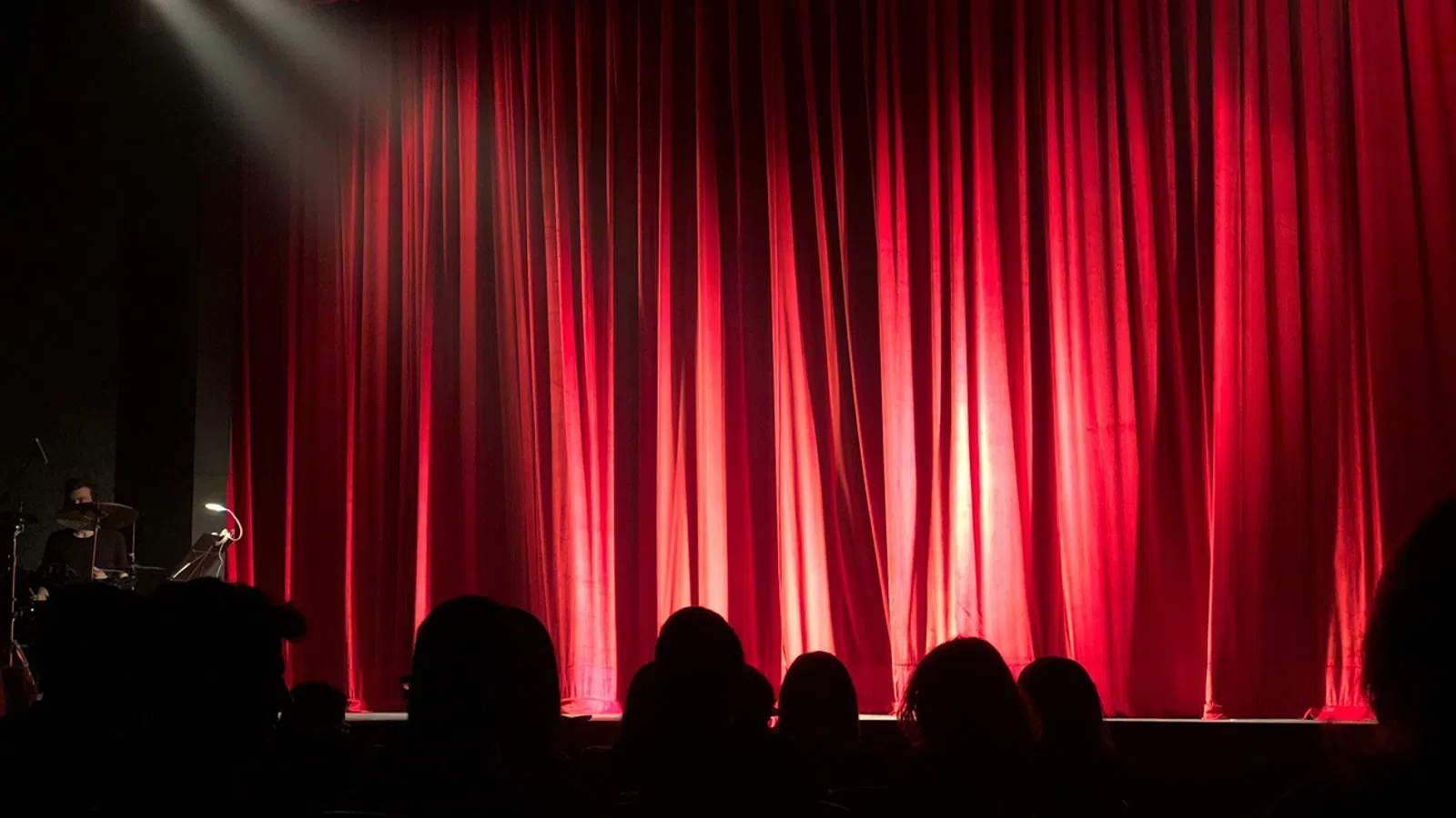 a stage with a red curtain