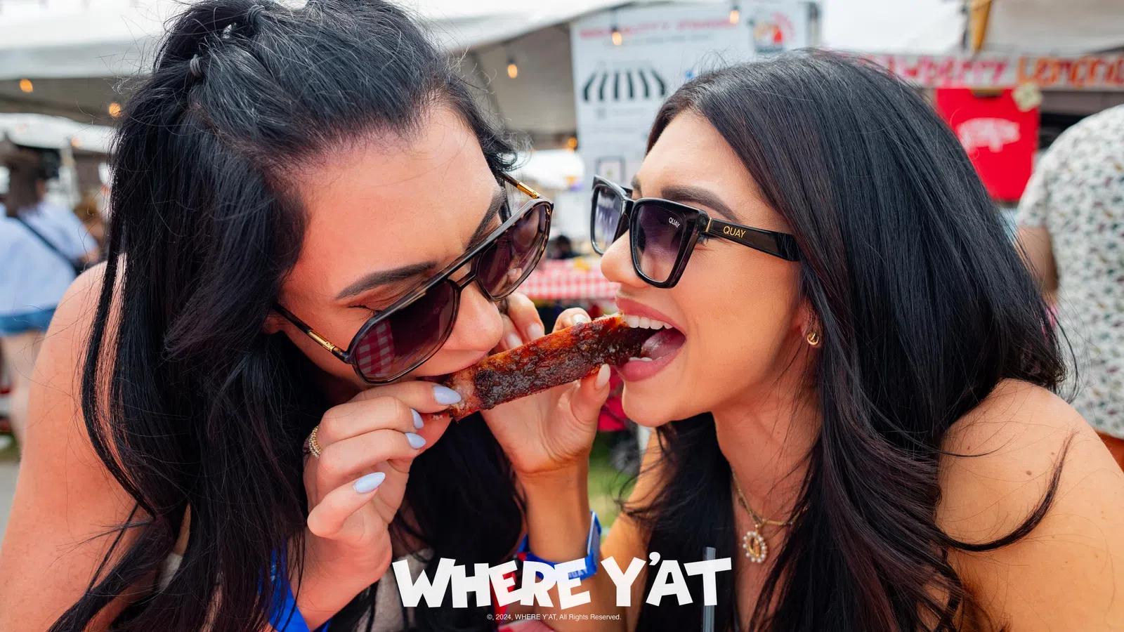 a couple of women eating pizza