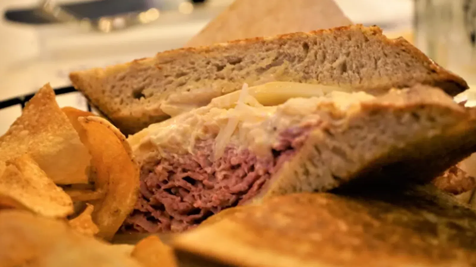 a sandwich with chips and salsa