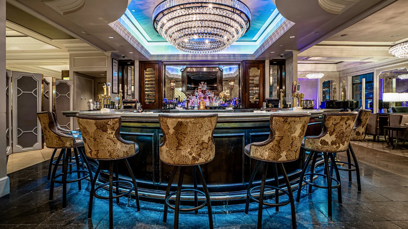 a bar with a large bar and chairs