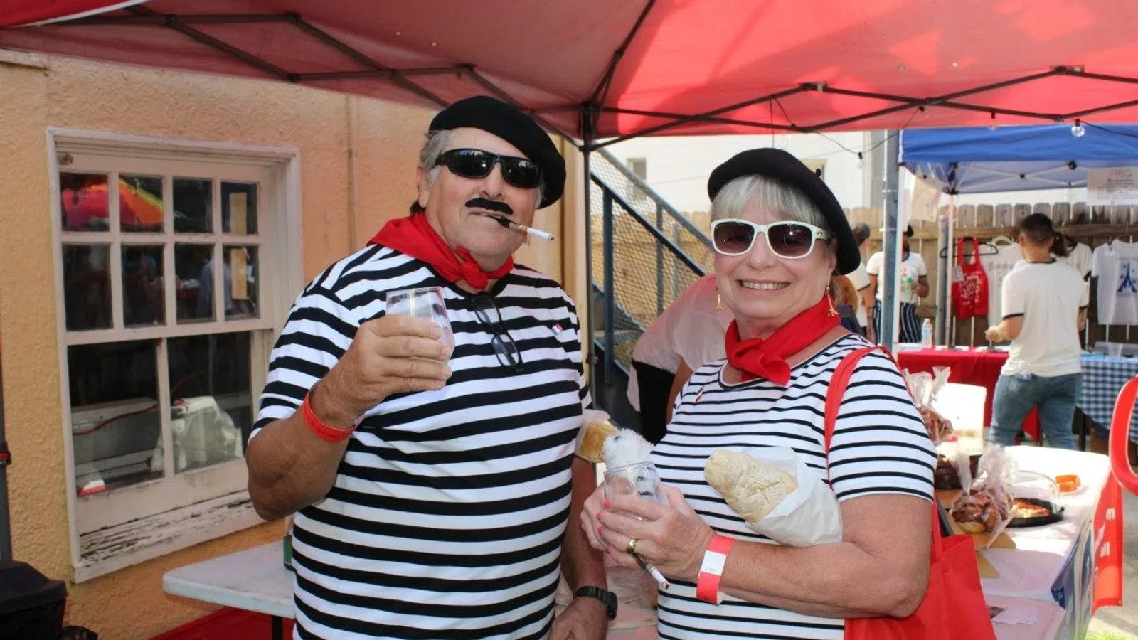 a couple of people wearing sunglasses and holding food