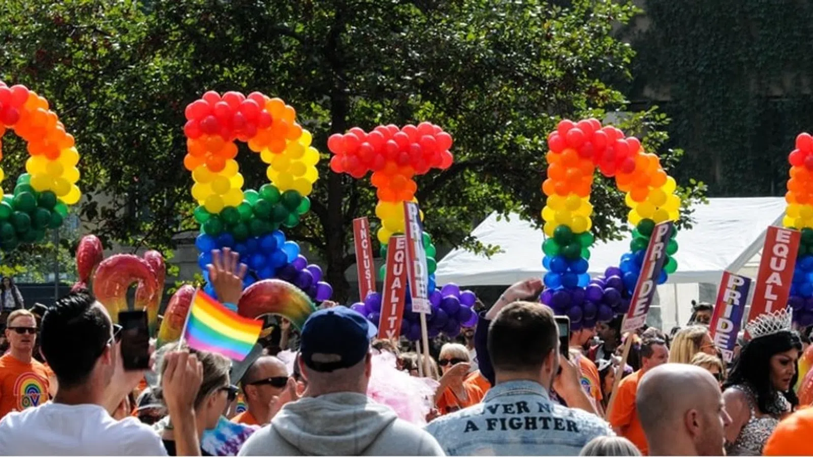a crowd of people holding balloons