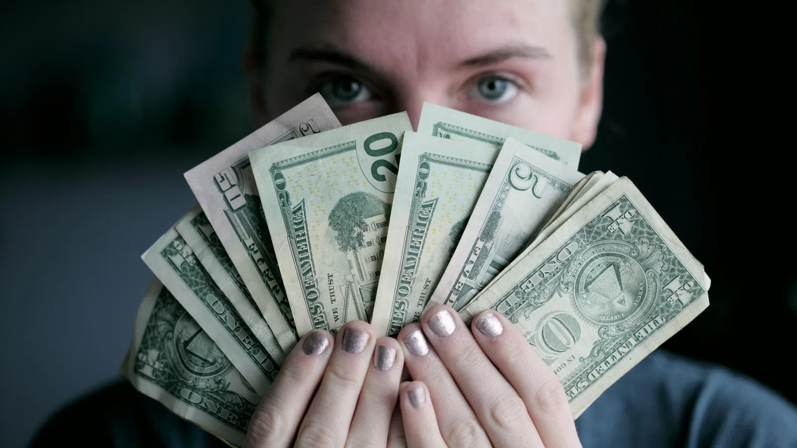 a person holding a stack of money