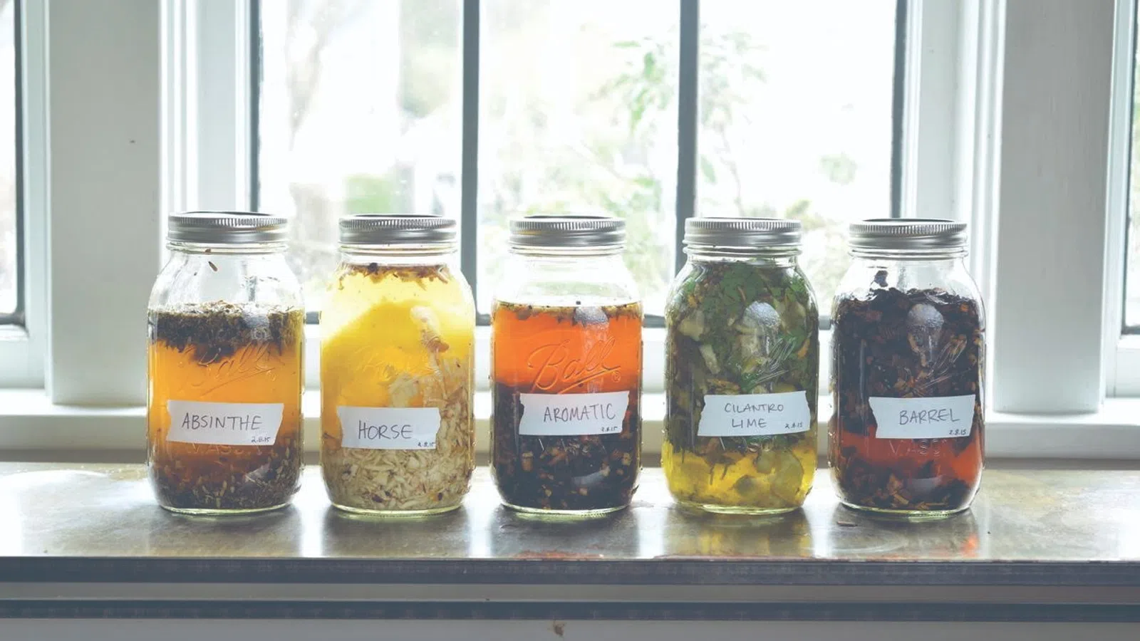 a group of jars with liquid in them
