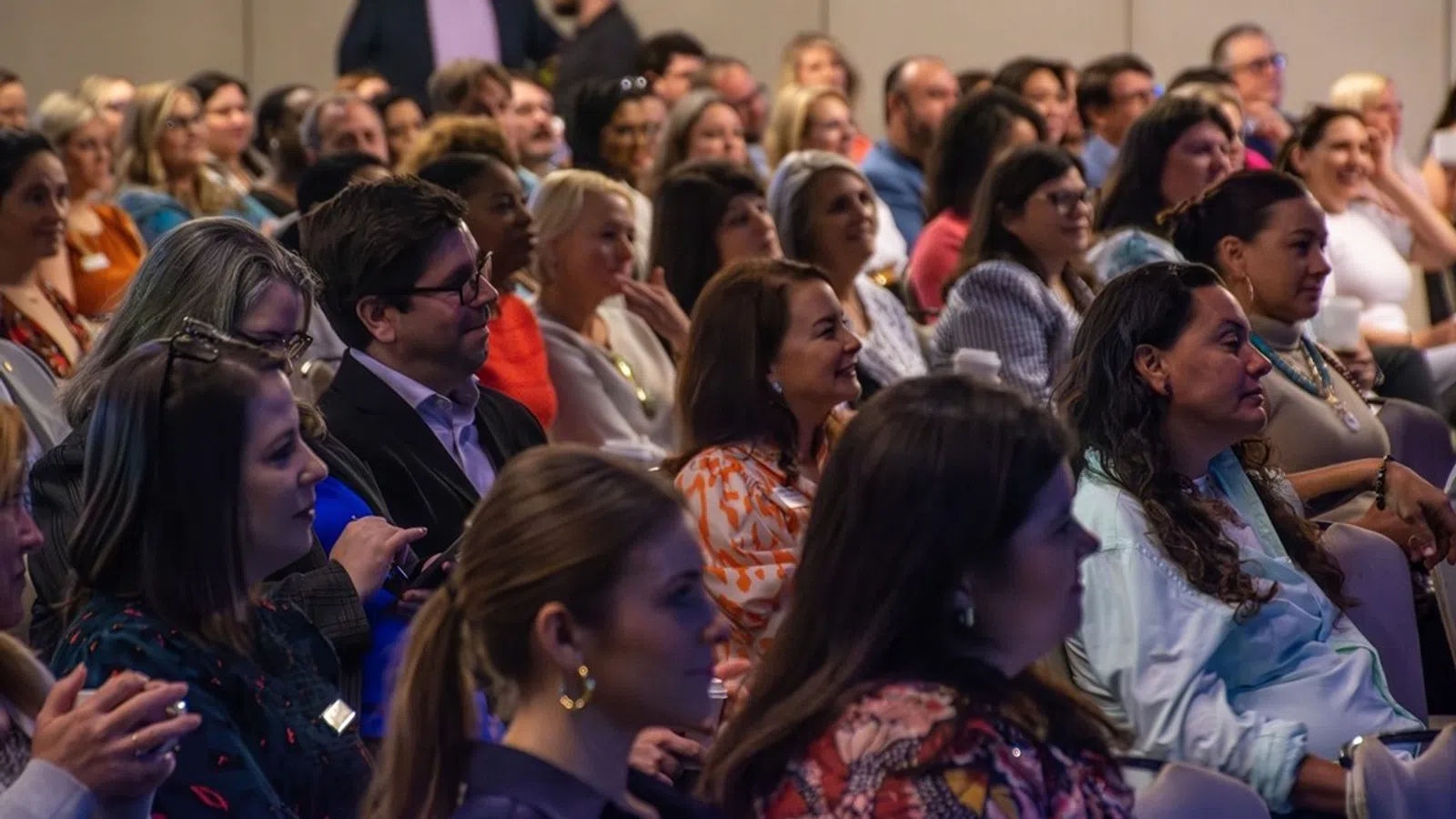 a woman addressing a group of people