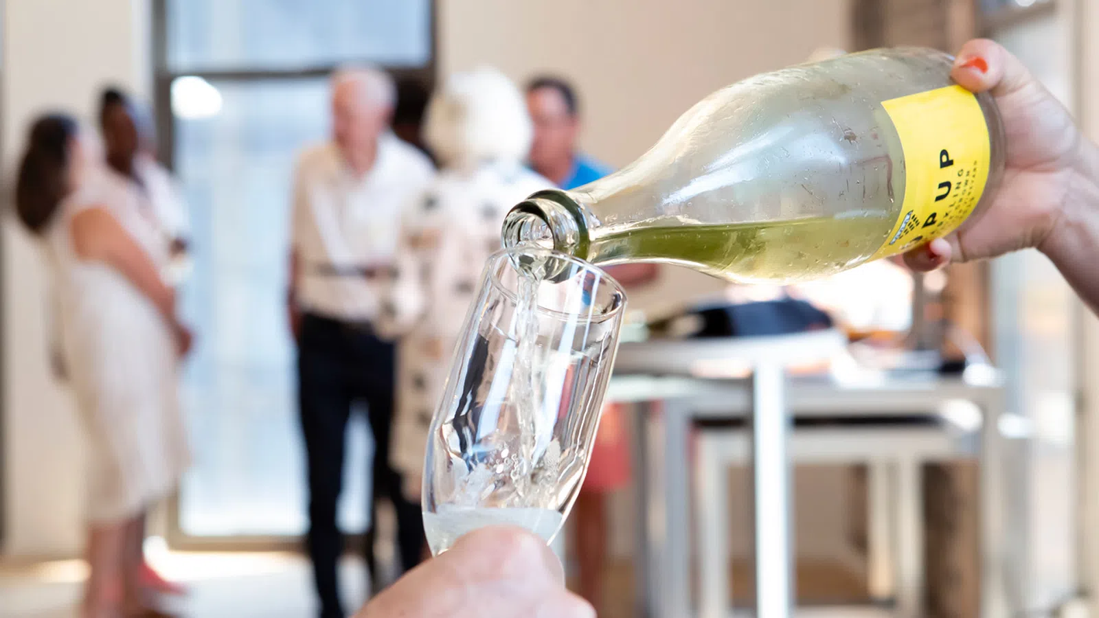 a hand holding a bottle of liquid