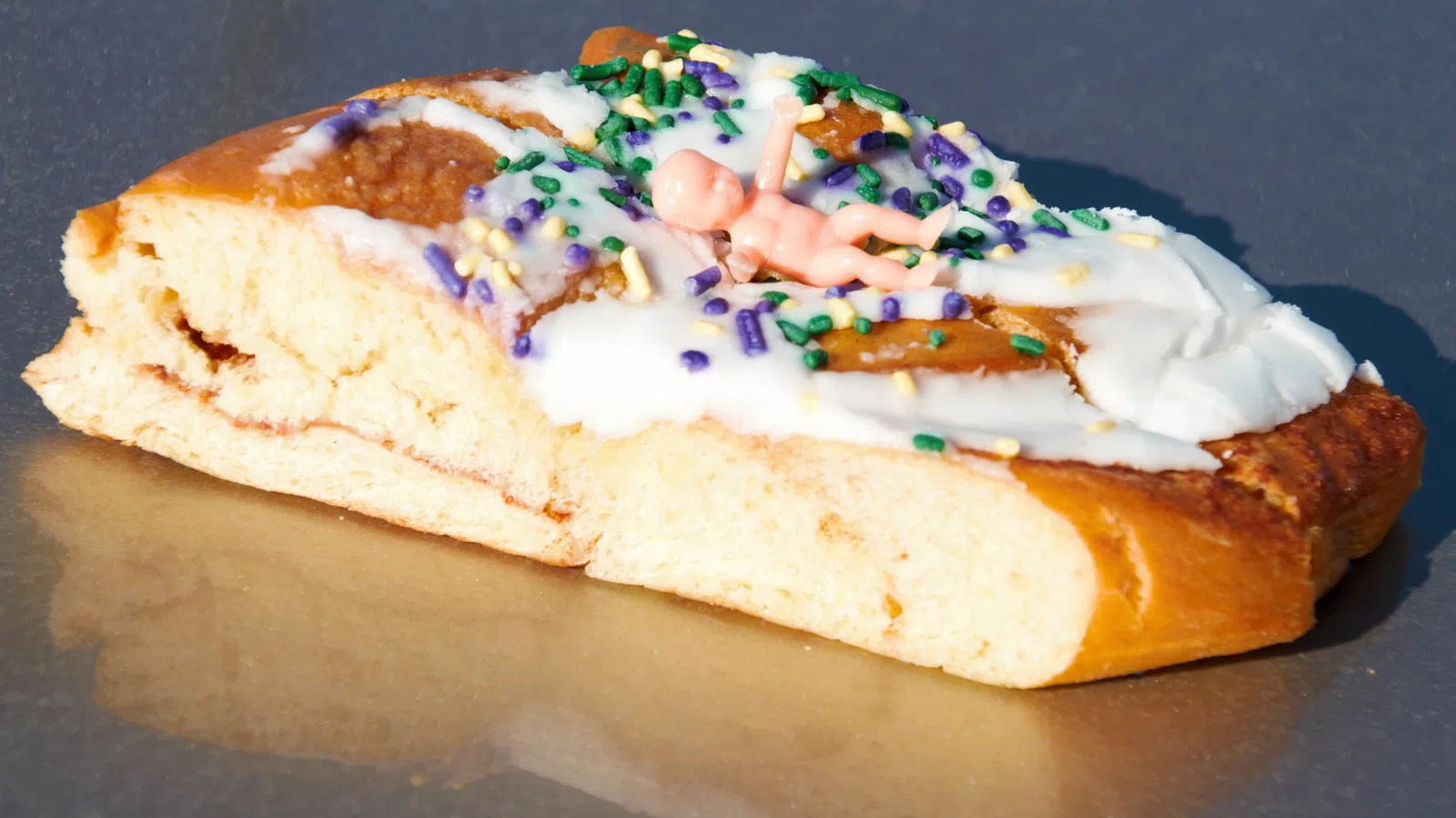 a piece of bread with colorful frosting and sprinkles on it
