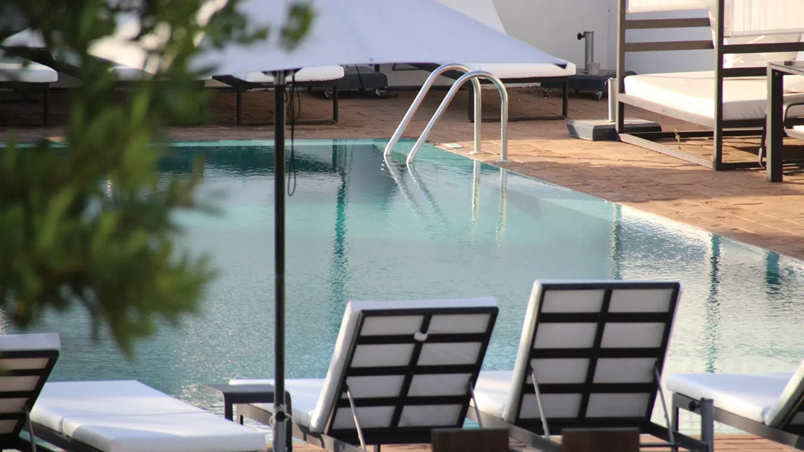 a pool with chairs around it