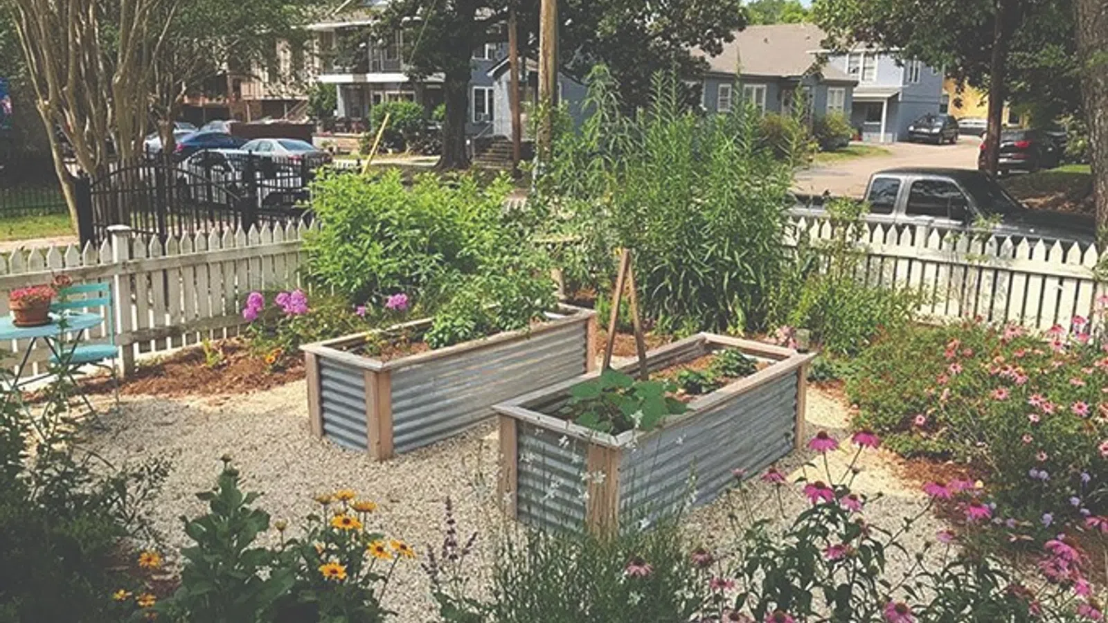 a garden with a bench and a fence