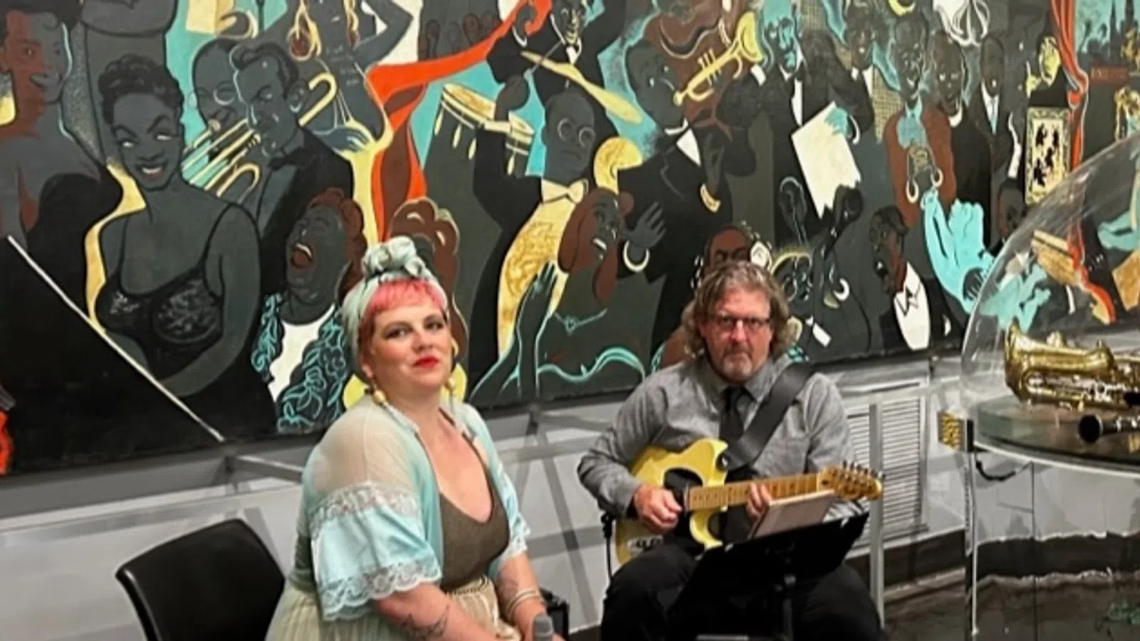 a man and woman playing guitar