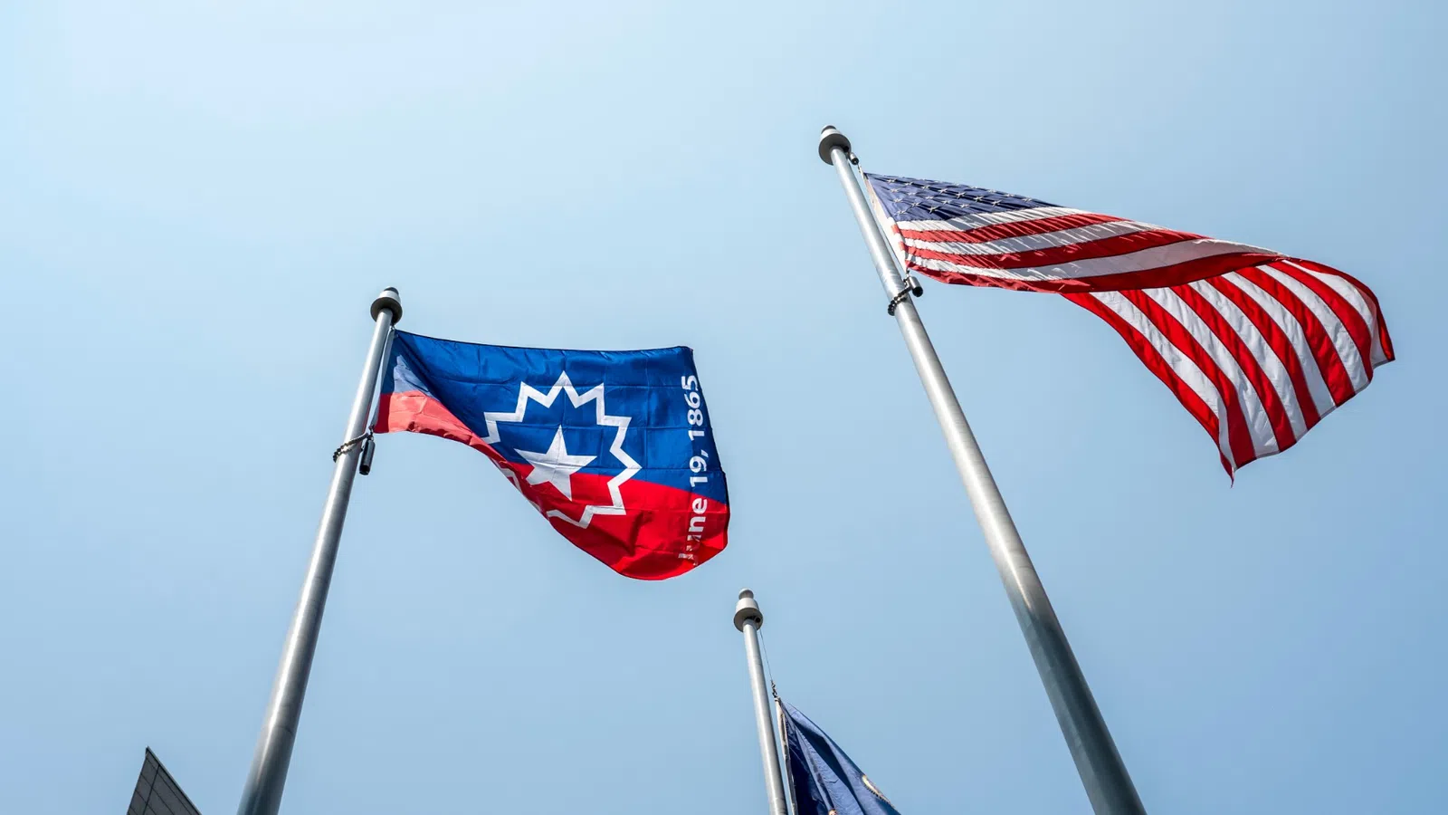 a group of flags on poles