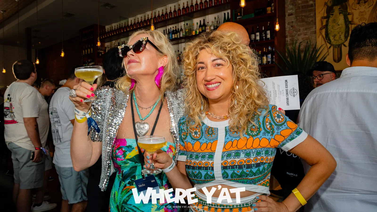 a couple of women holding drinks