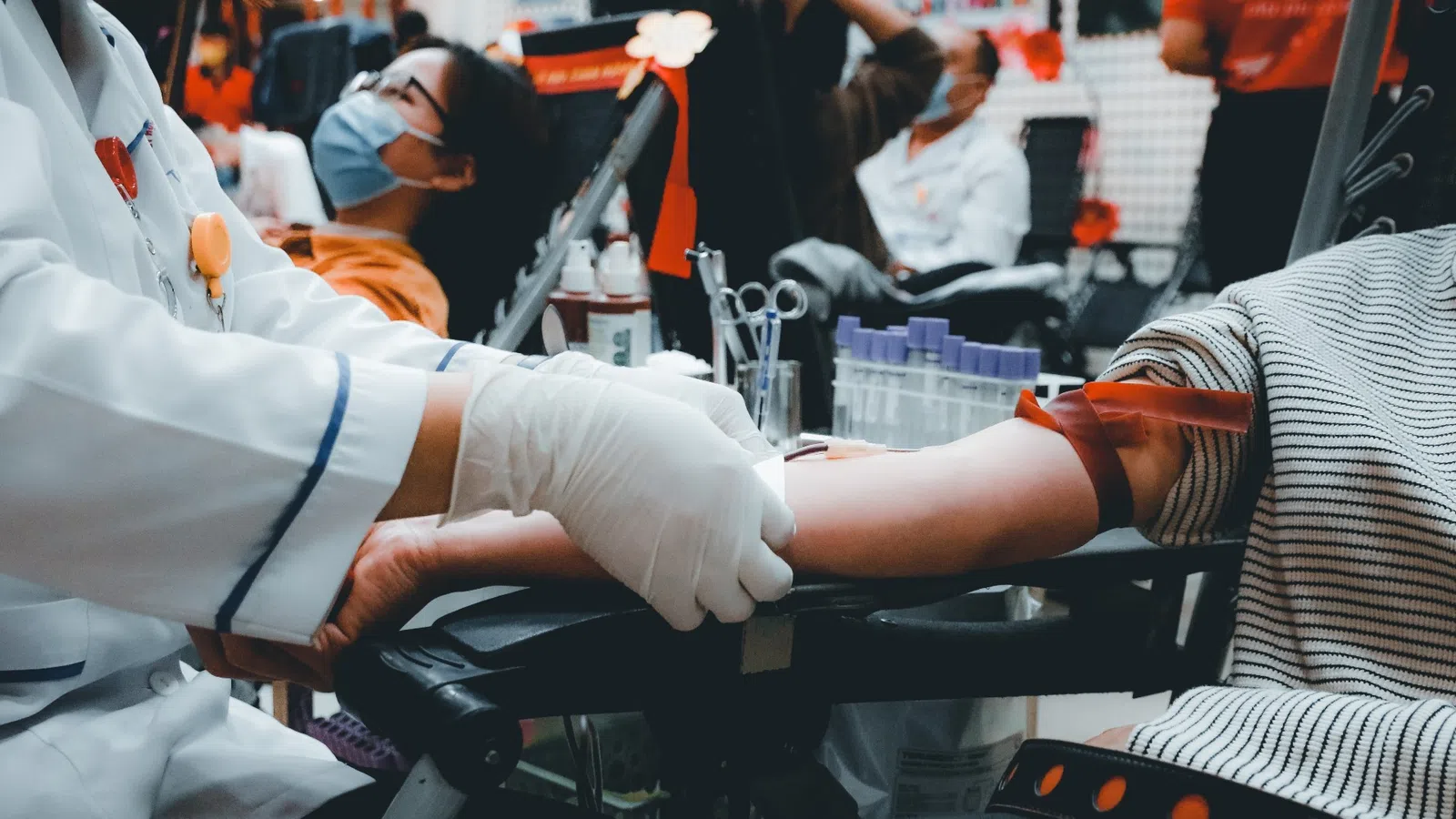 a person in a wheelchair being examined by a doctor