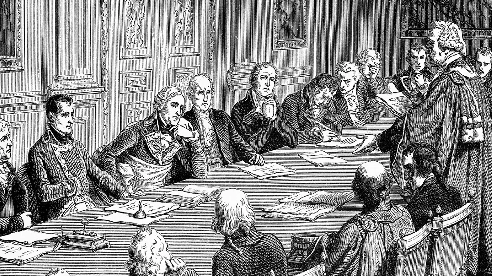 Black and white engraving of a historical meeting with men in 18th-century attire seated around a large table.