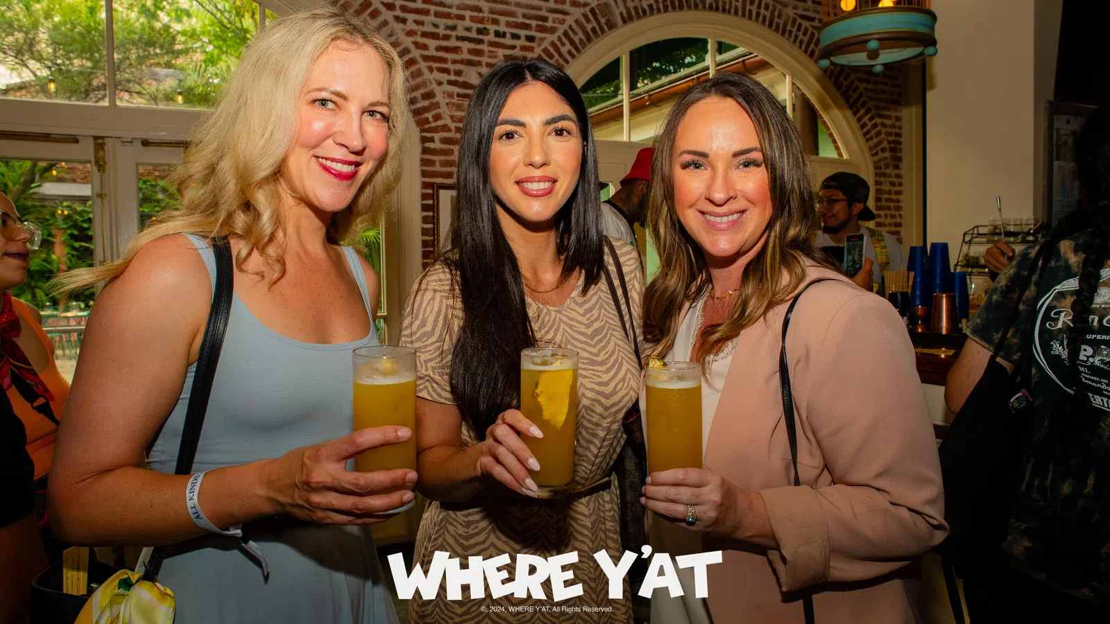 a group of women holding glasses of beer