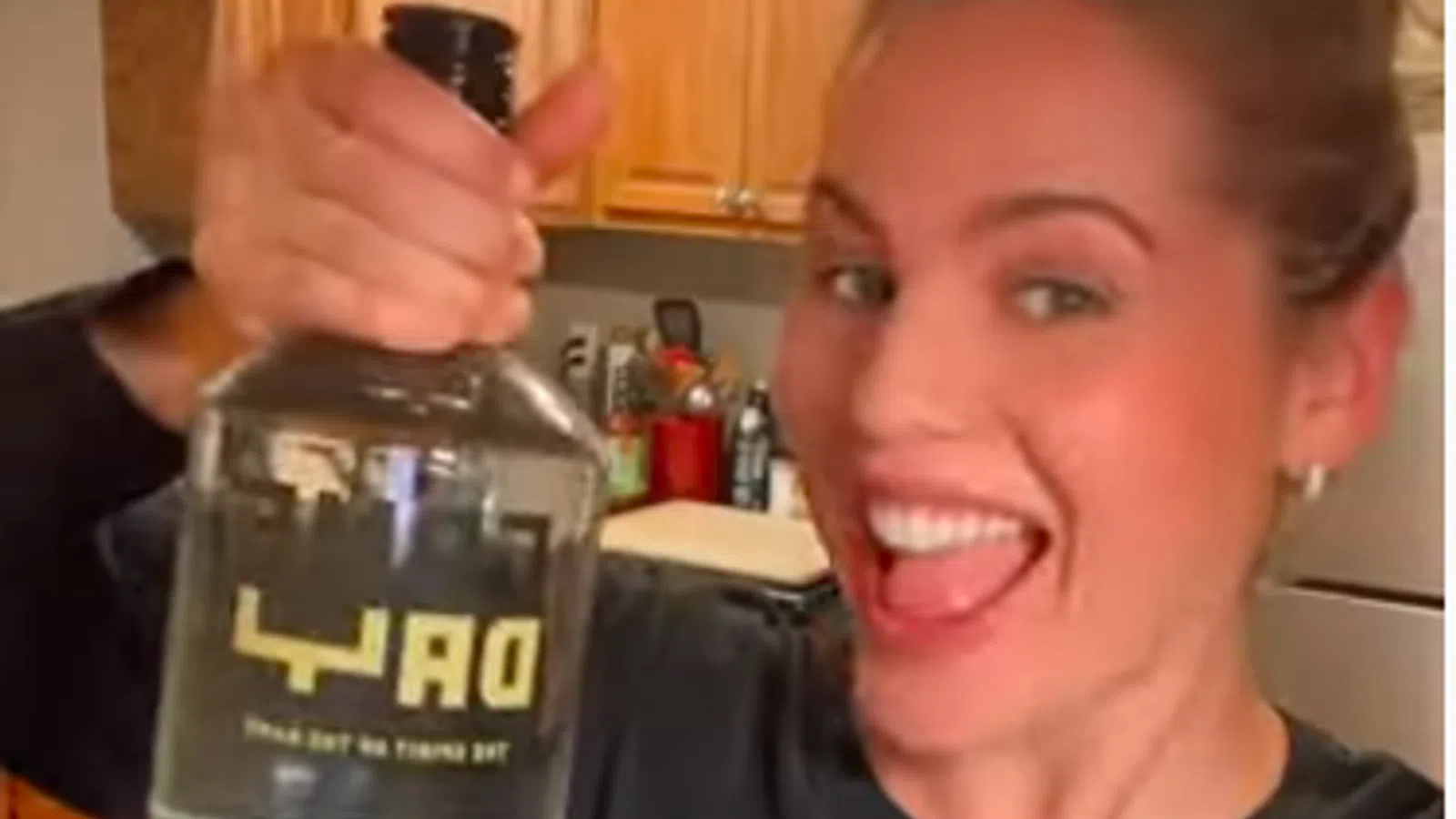 a woman holding a bottle