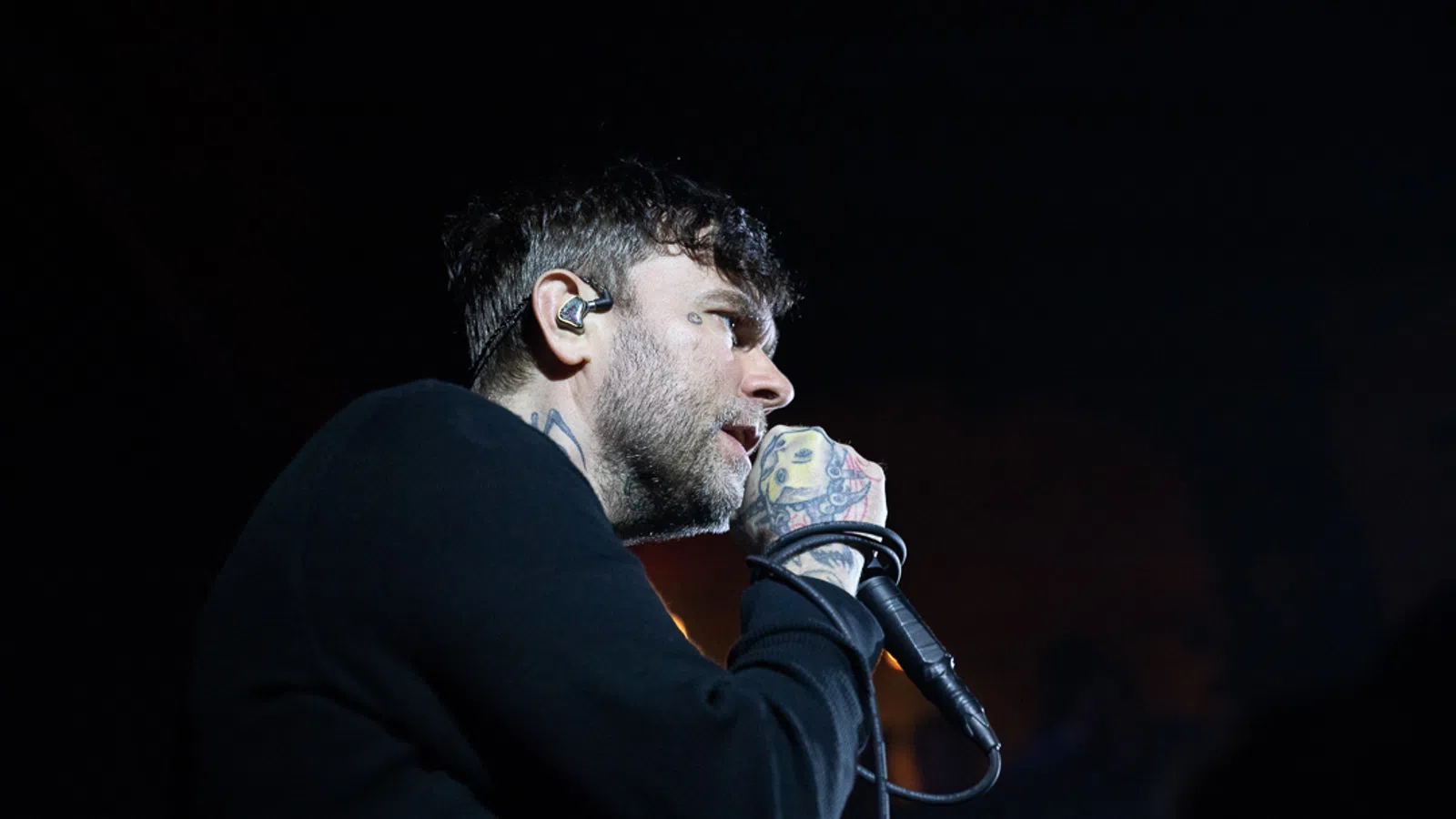 a man with a beard and a microphone
