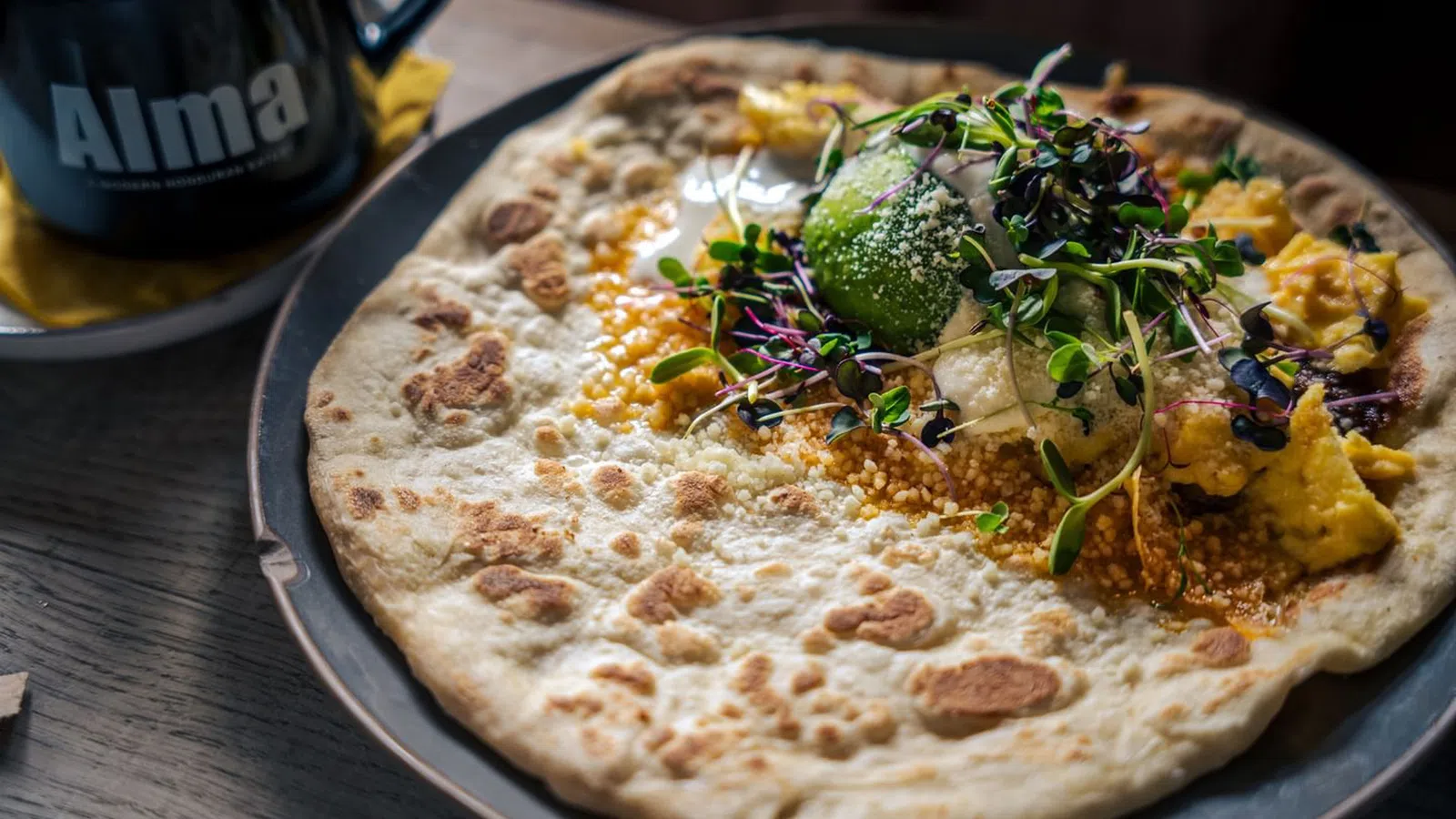 a pizza with broccoli and cheese on a plate