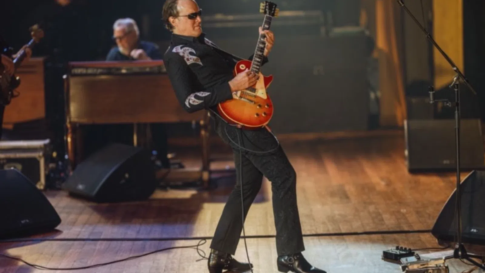 a person playing a guitar on a stage
