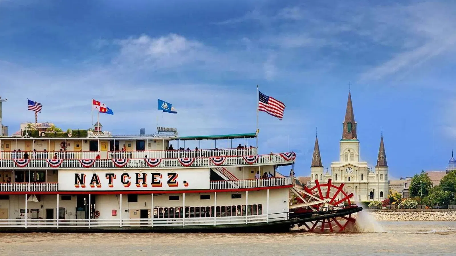 Steamboat Natchez on the Mississippi River, with New Orleans skyline in the background.
