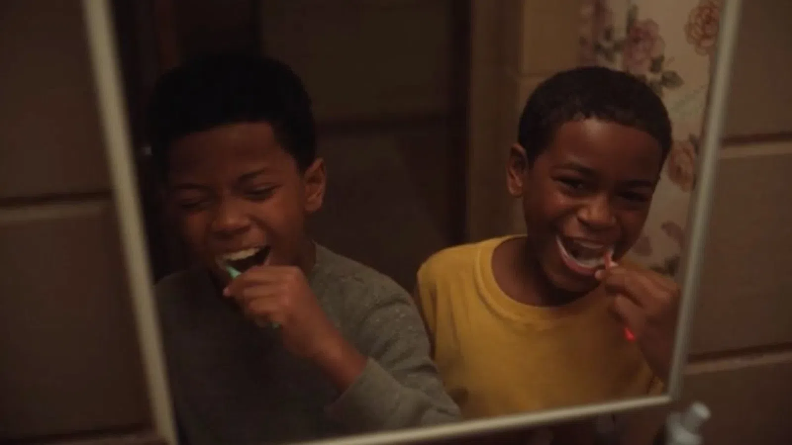 a couple of boys brushing their teeth