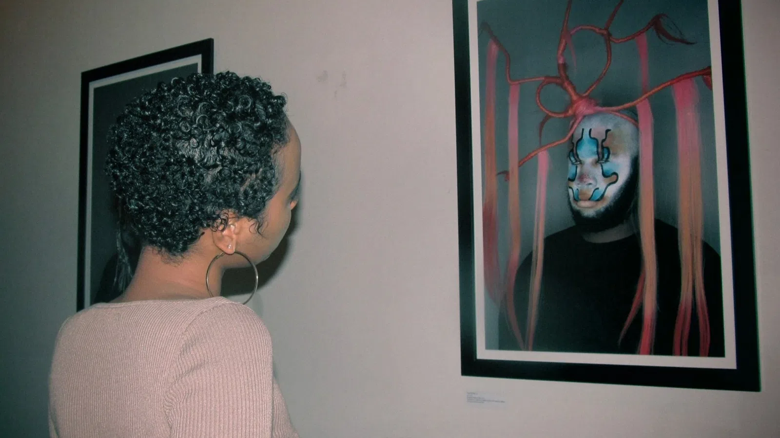 a man looking at a painting