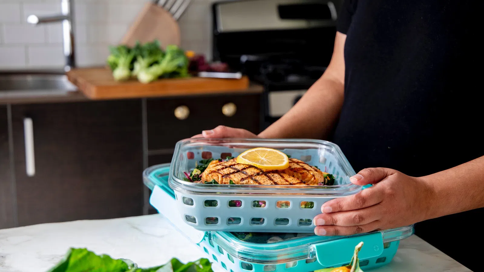 a person putting food in a dish