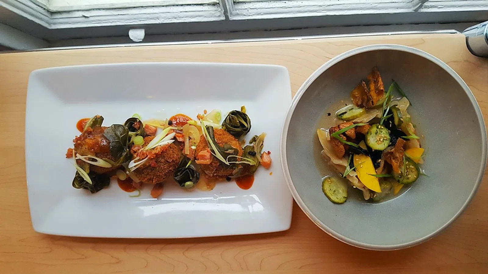 Delicious plated dish featuring vegetables and crispy fried items on a wooden table.