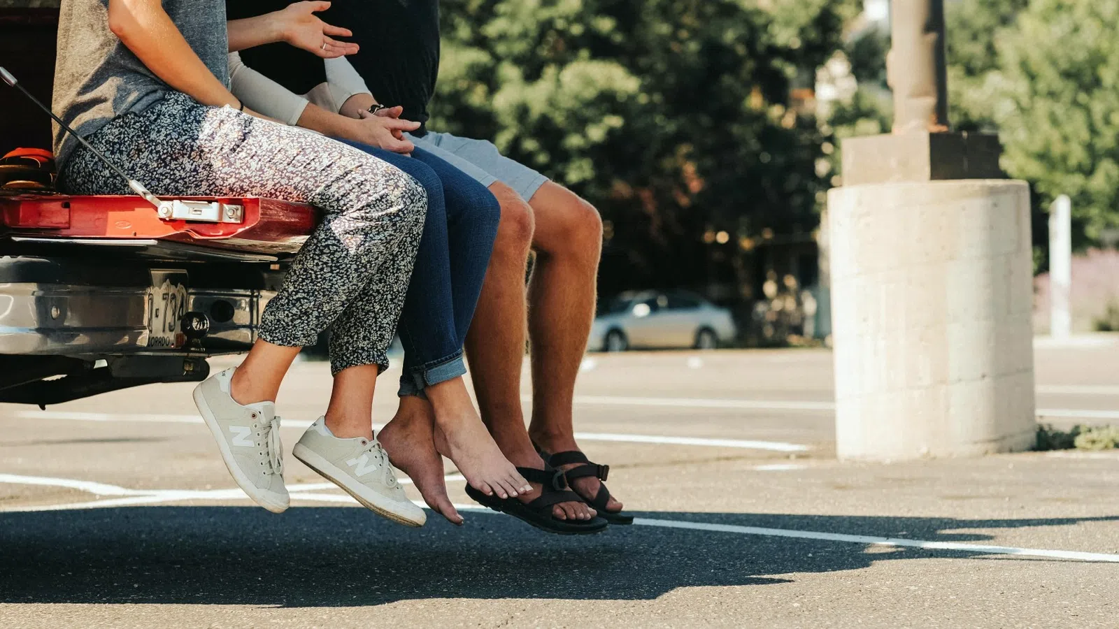 a man and woman sitting on a red truck
