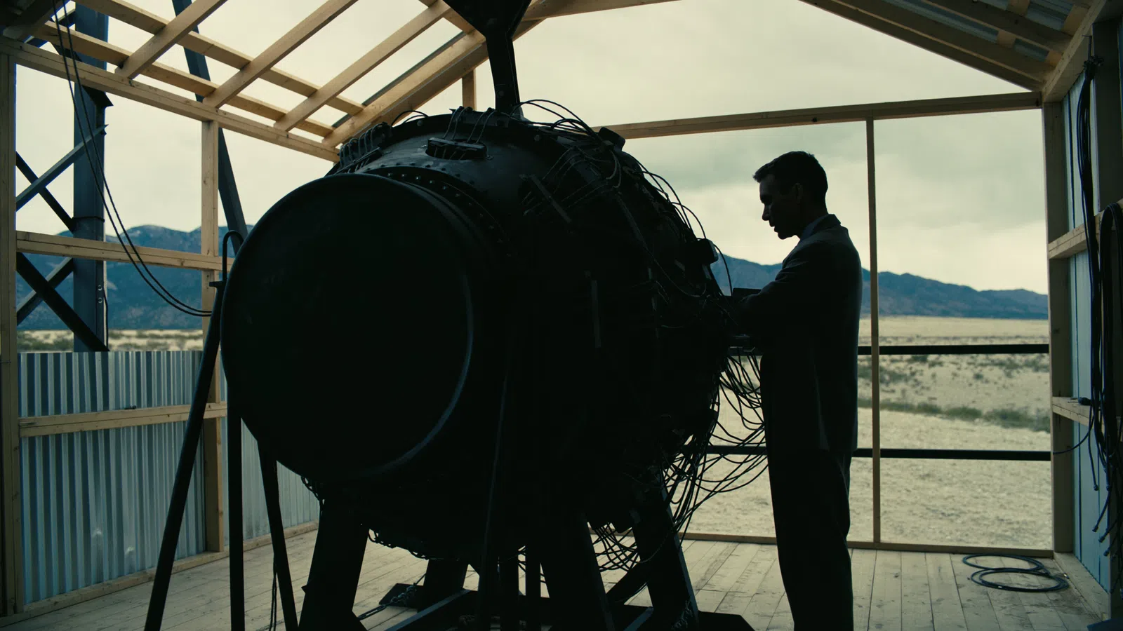 a person standing next to a large tire