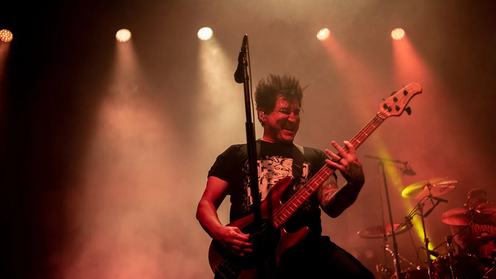 a man playing a guitar on a stage