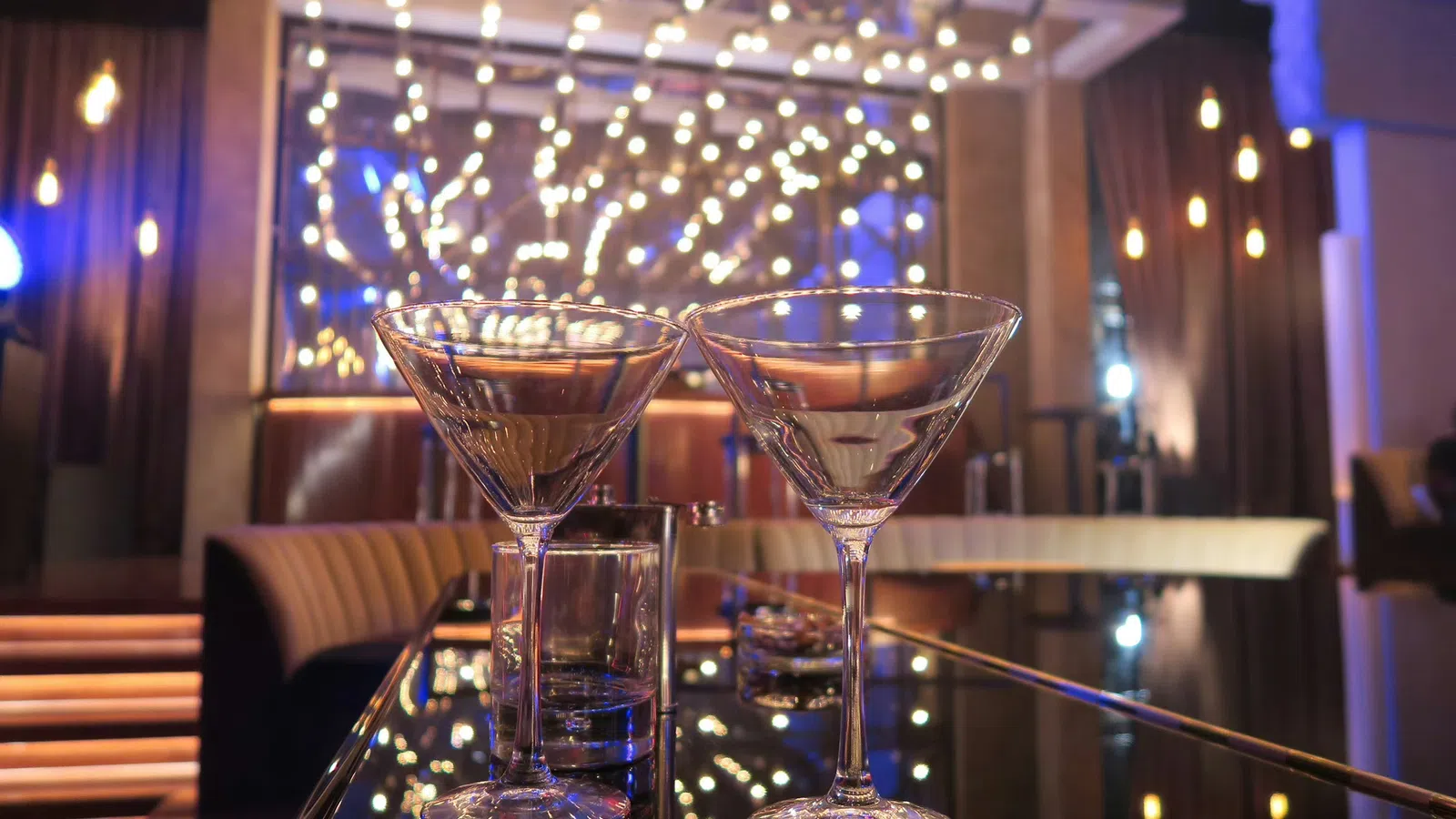 a couple of wine glasses on a bar
