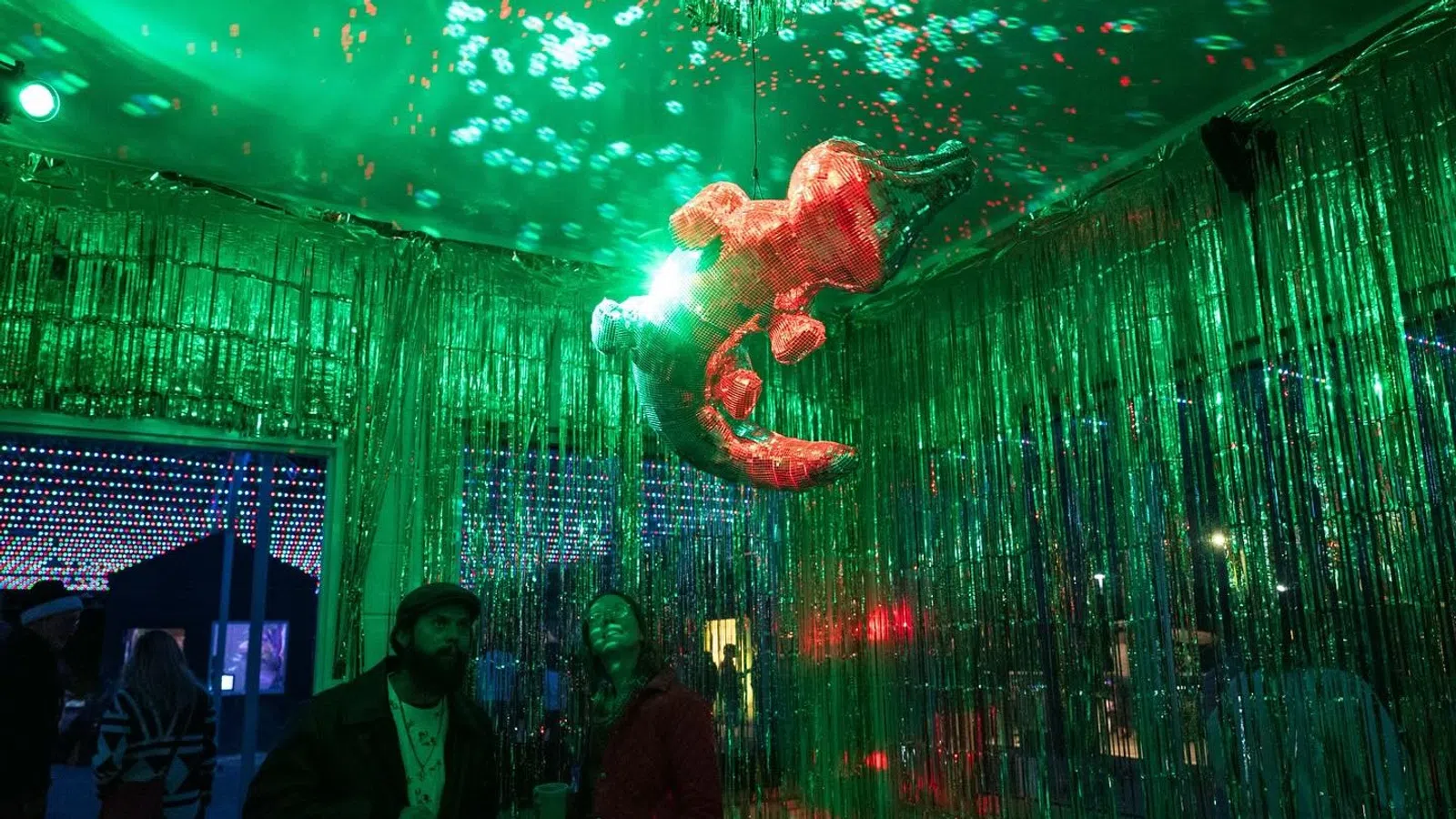 a person holding a fish in the air in front of a crowd