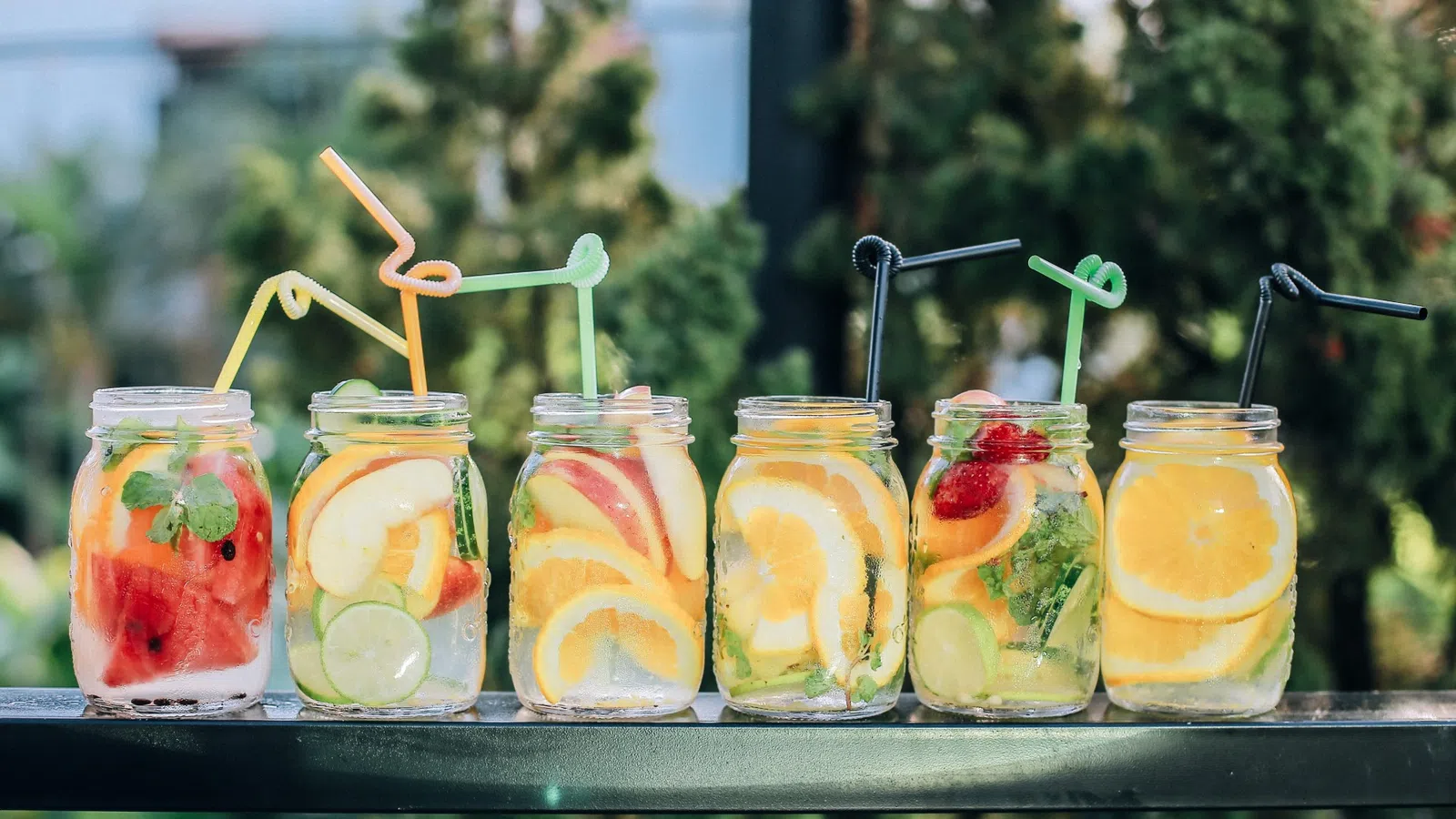 a group of glass jars with fruit in them