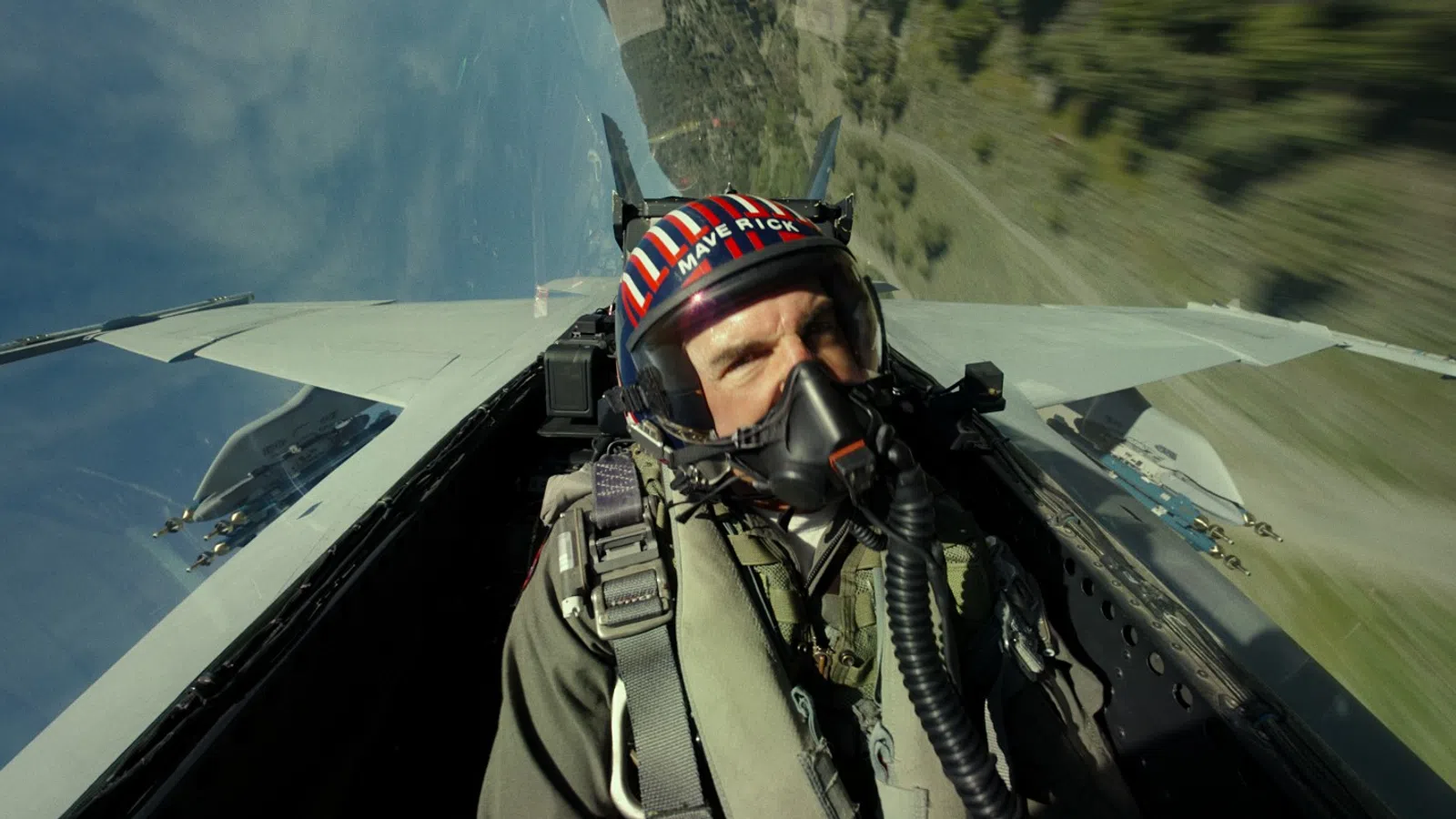 a person in a military uniform flying a plane
