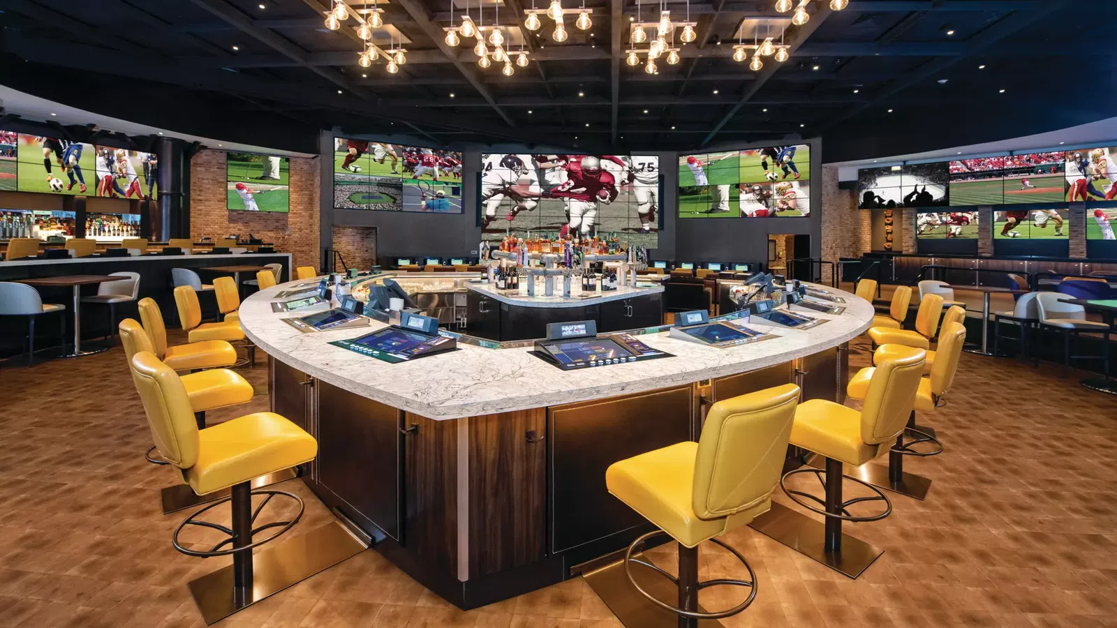 a bar with yellow chairs