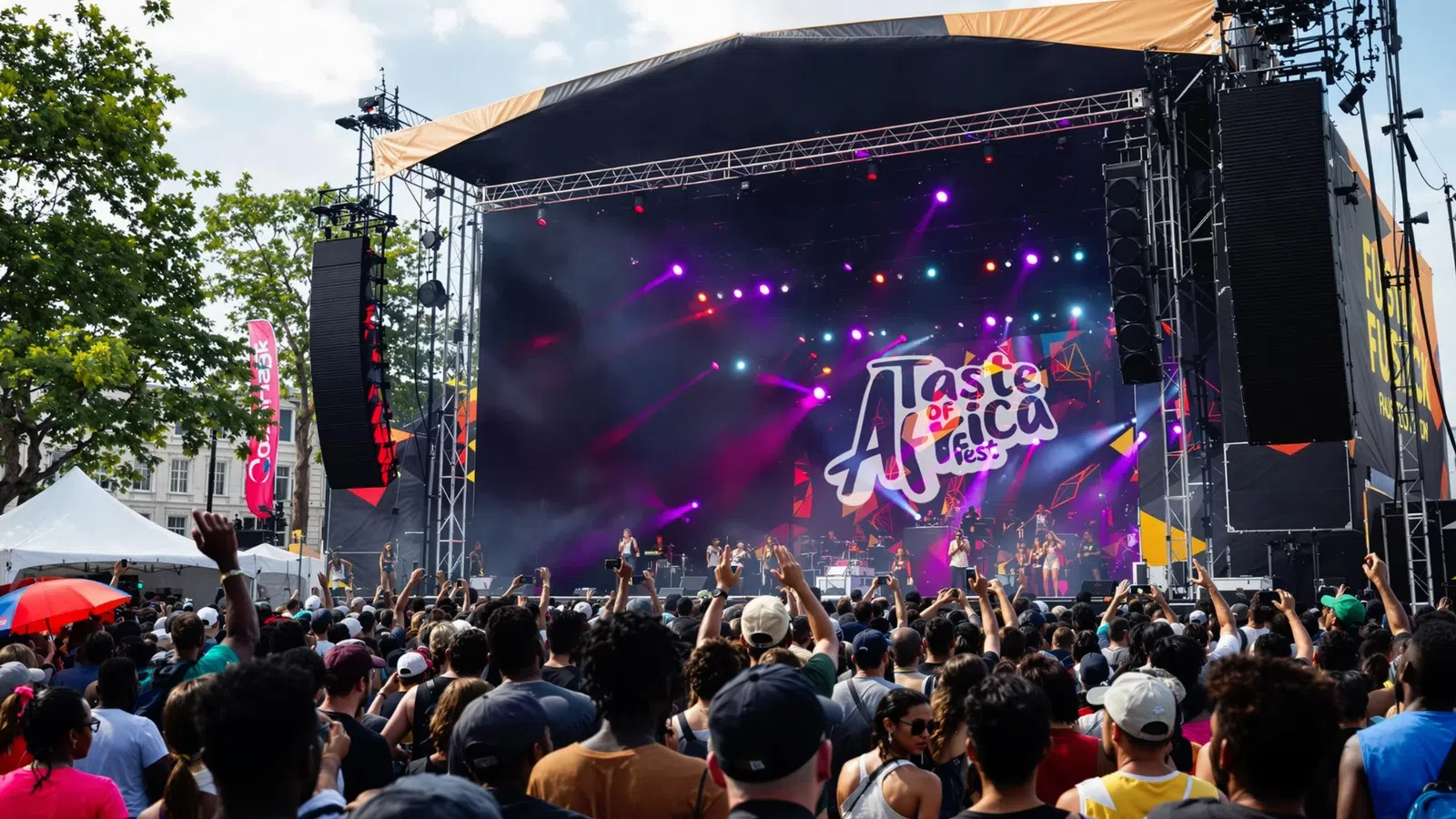 Large crowd enjoying live music at a vibrant outdoor Taste of Africa Fest stage with colorful lights