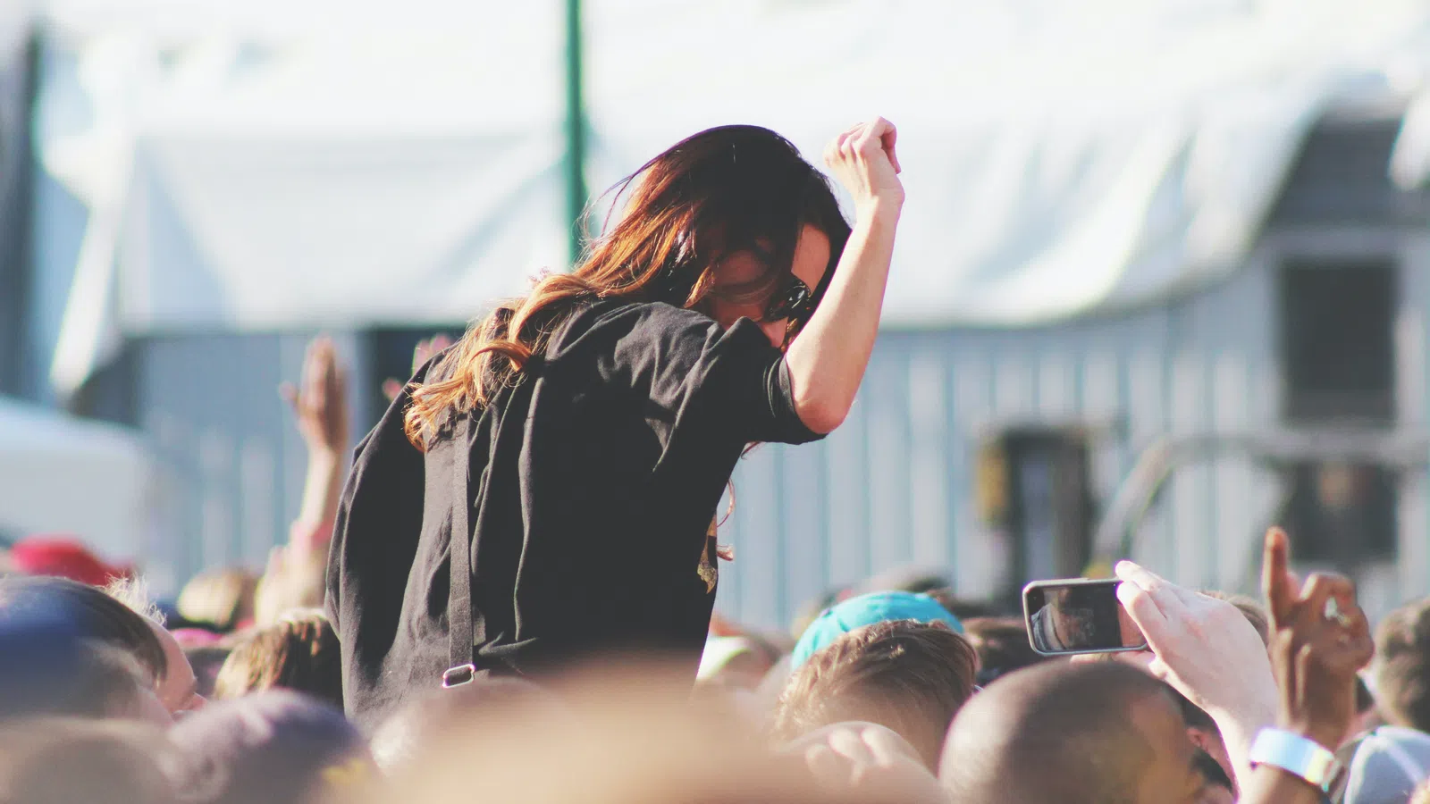 a person with long hair on stage
