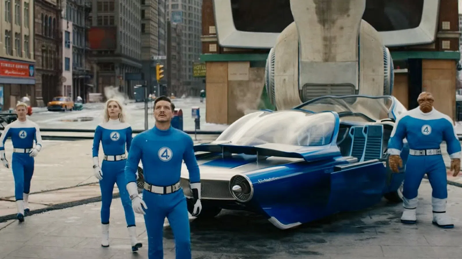 Fantastic Four superheroes in blue suits stand near their futuristic blue vehicle in a city setting.