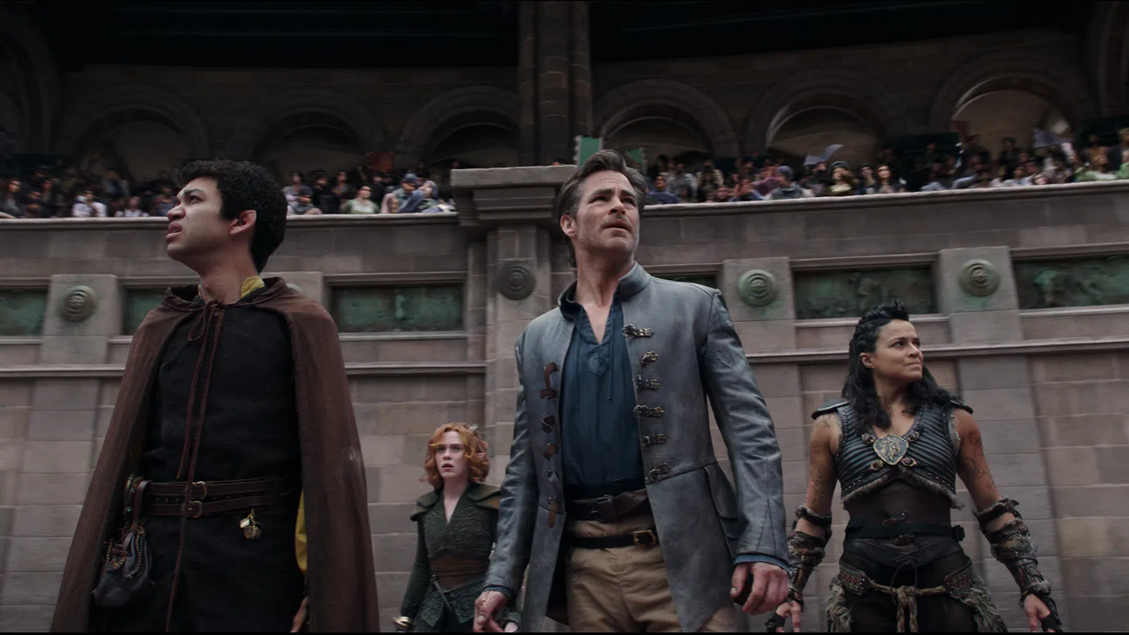 a group of people standing in front of a building with a large group of people in the background