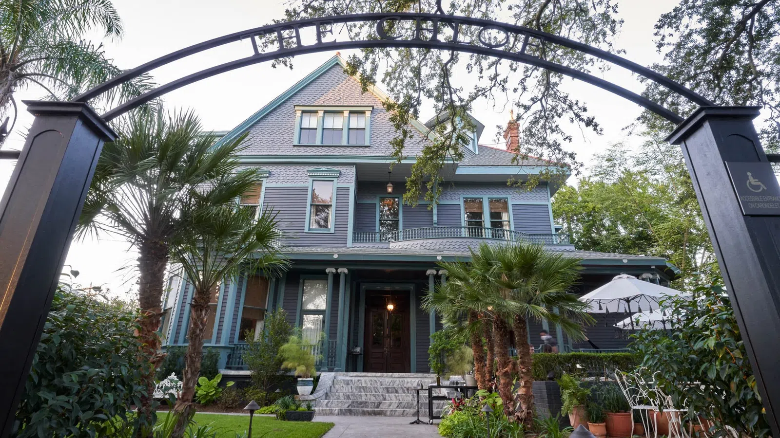 a house with palm trees and a walkway