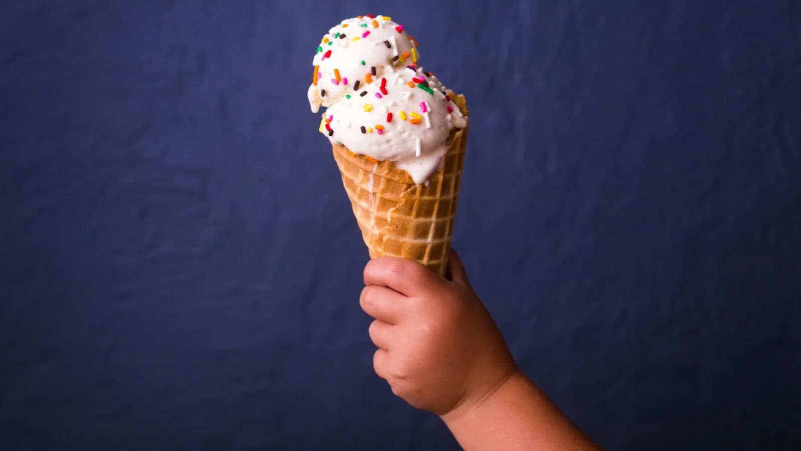 a person holding an ice cream cone