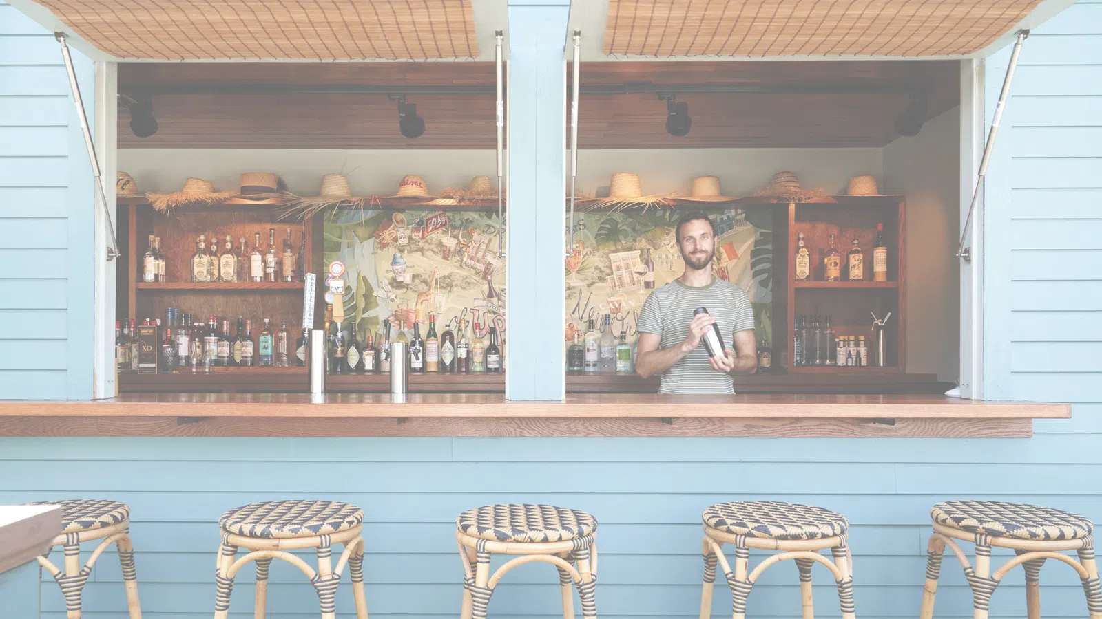 a person standing behind a bar