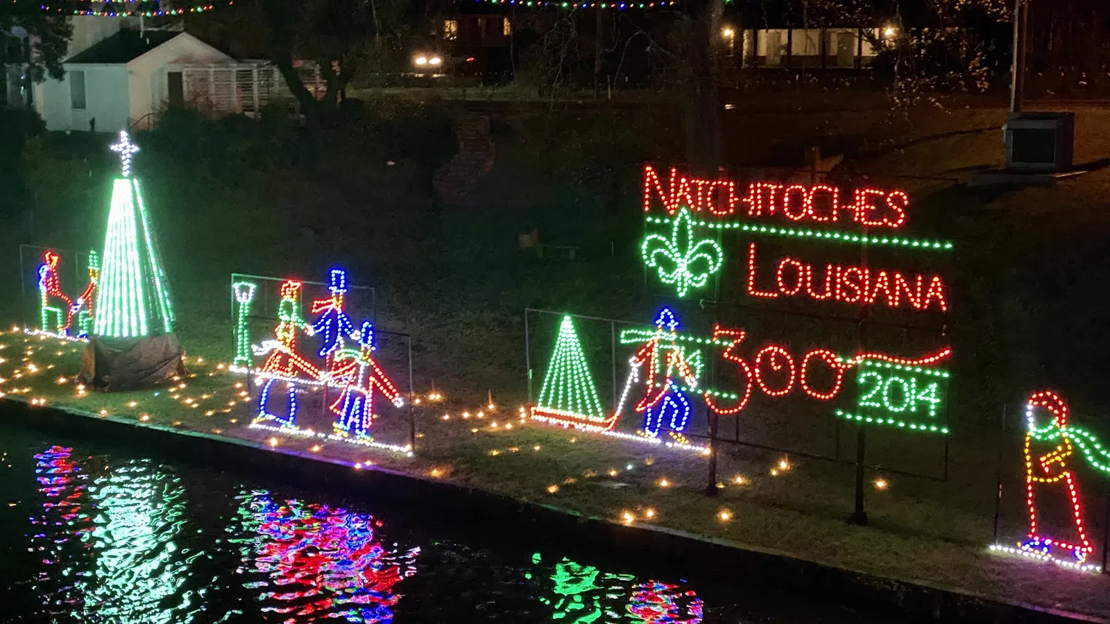 a sign with lights and a fountain