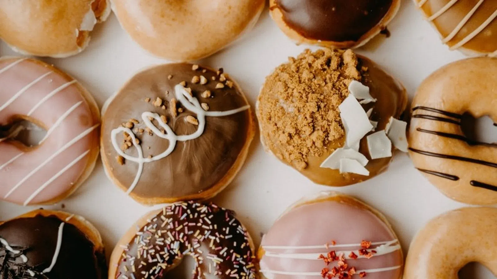 a group of donuts with frosting and sprinkles