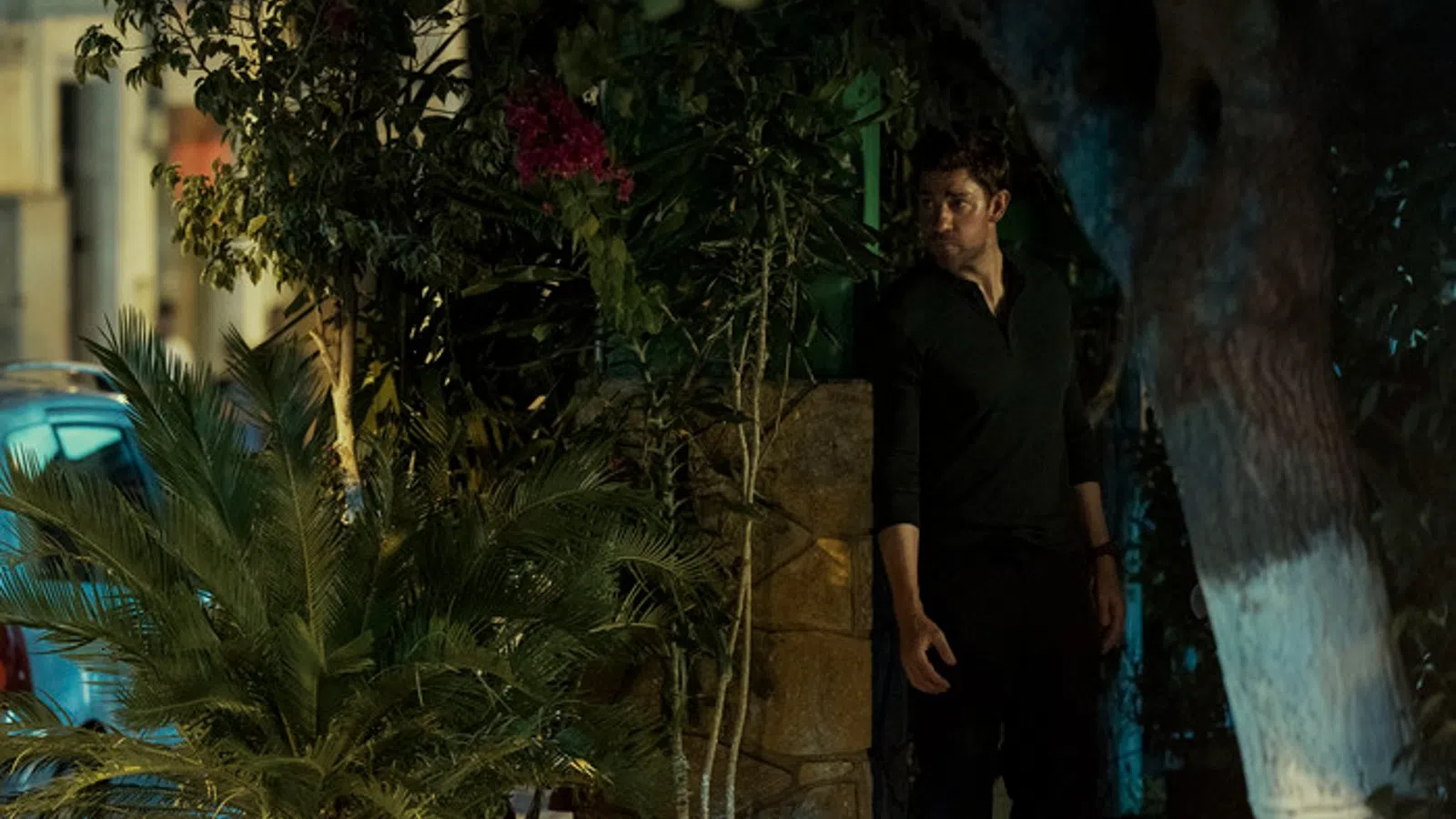a man standing next to a tree