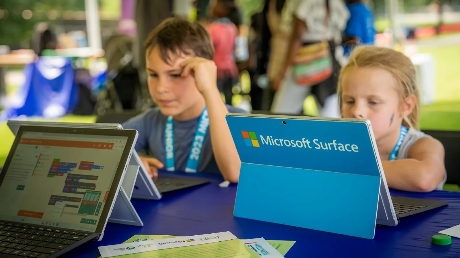 children using laptops at a table